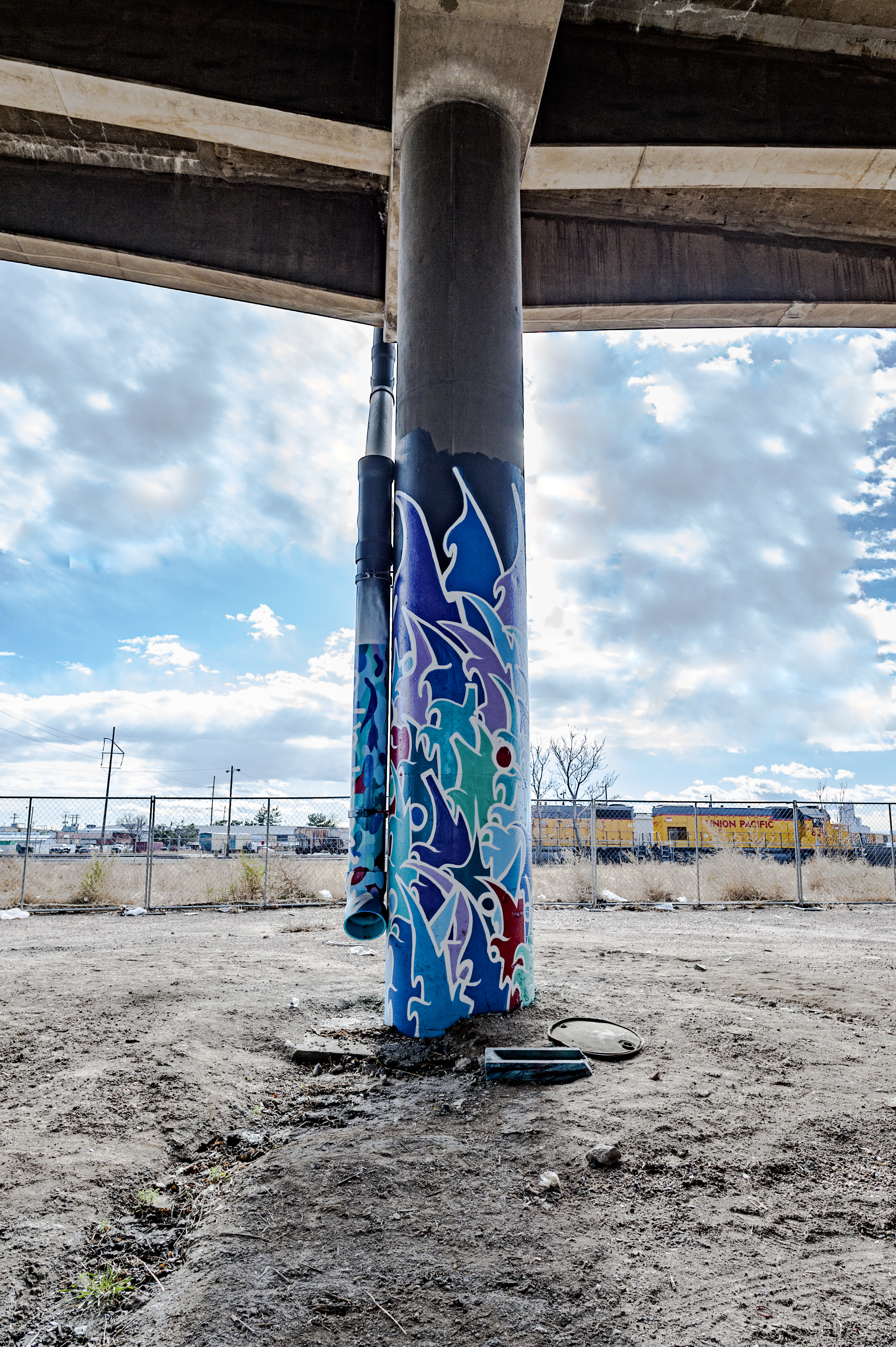 Untitled (blue stylized graffiti-style artwork on two columns)