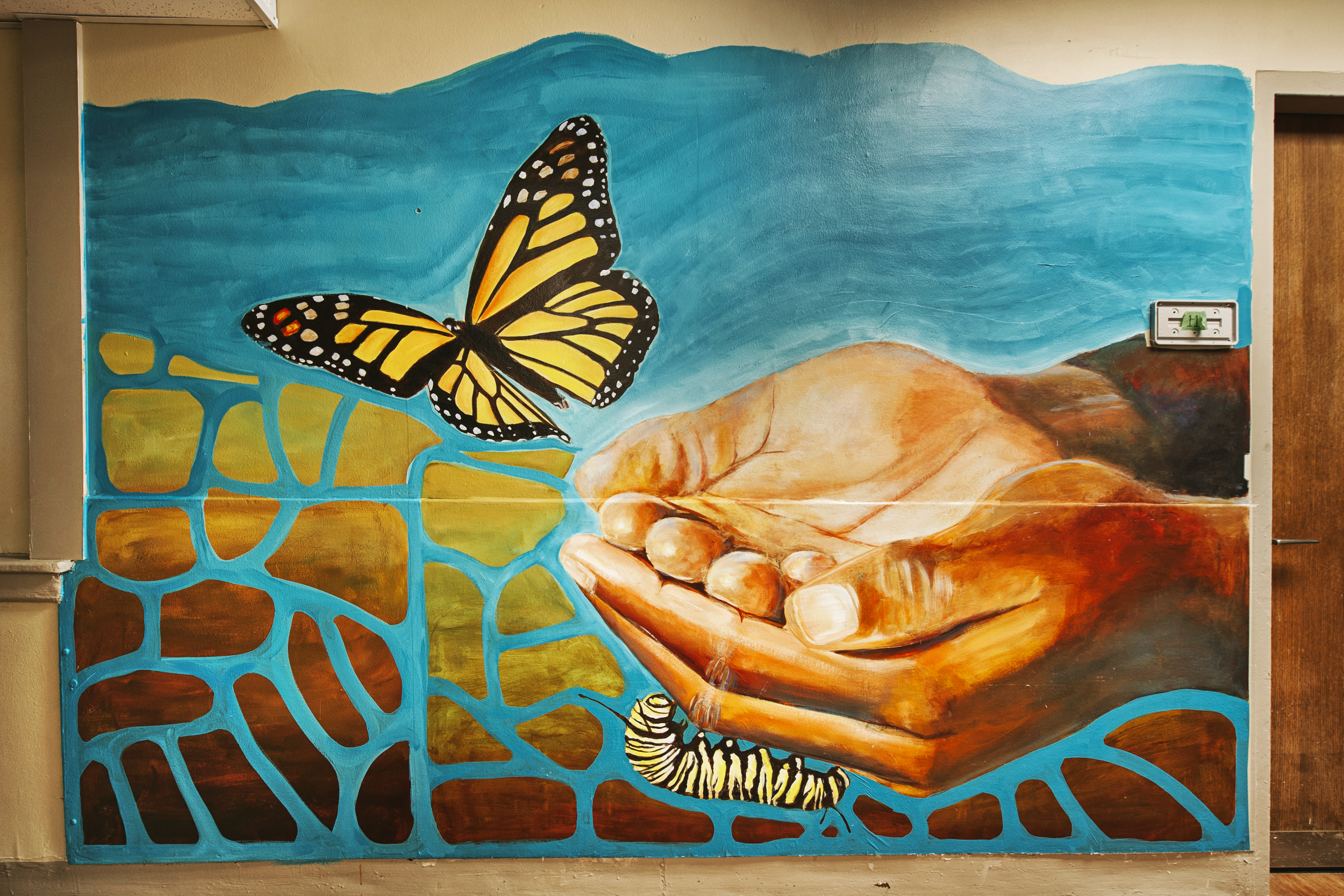 Untitled (hands releasing a monarch butterfly)