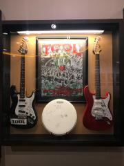 Display case; Tool electric guitars/drumhead/poster