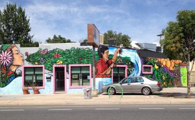 Untitled (Latina woman blowing foliage and Cesar Chavez watering plants)