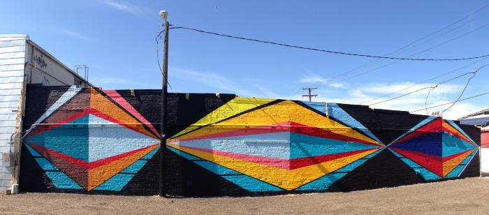 Untitled (geometric colored shapes on fence and walls)