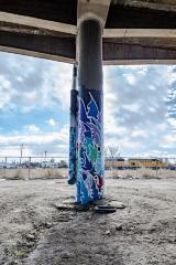 Untitled (blue stylized graffiti-style artwork on two columns)