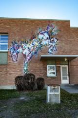 Untitled (a white horse jumping down from overhang) 