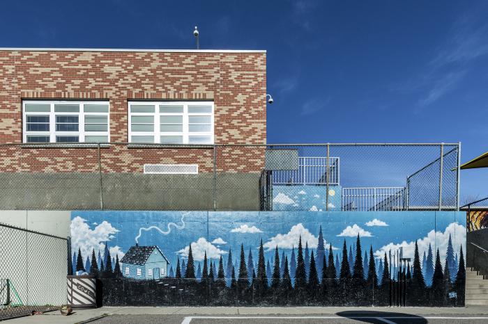 Untitled (mountain landscape, trees, house, blue sky with clouds)