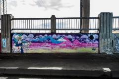 Untitled (girl in front of pink pyramids with paper airplane)