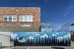 Untitled (mountain landscape, trees, house, blue sky with clouds)