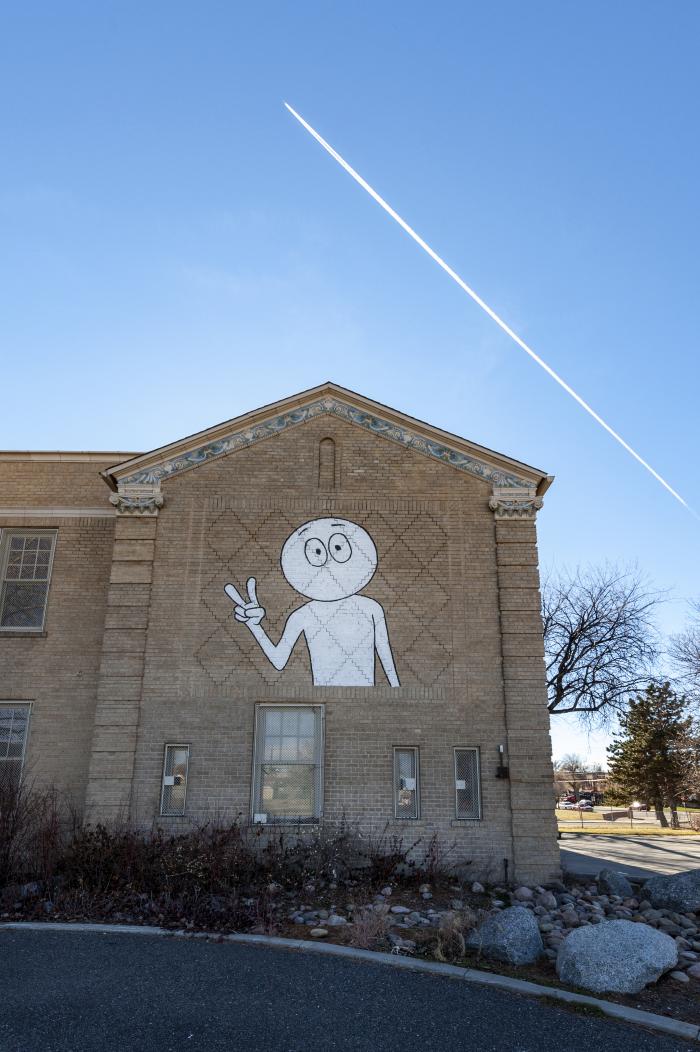 Untitled (boy making peace sign with fingers