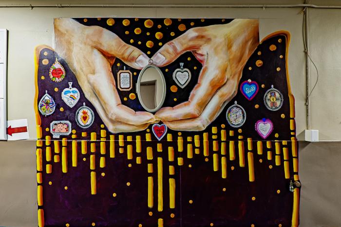 Untitled (hands opening up a locket holding a mirror)